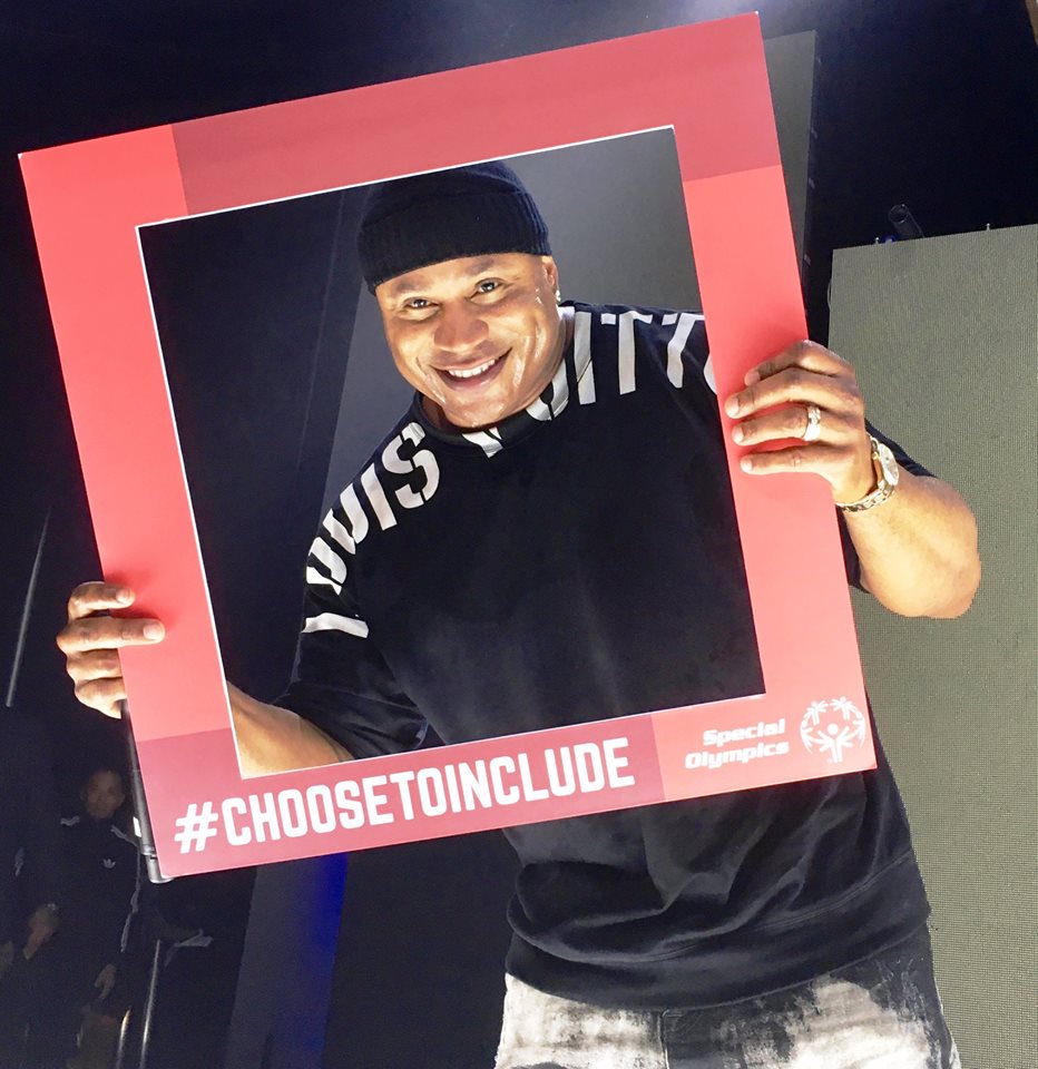 LL Cool J holds up Daina's #CHOOSETOINCLUDE sign during his performance