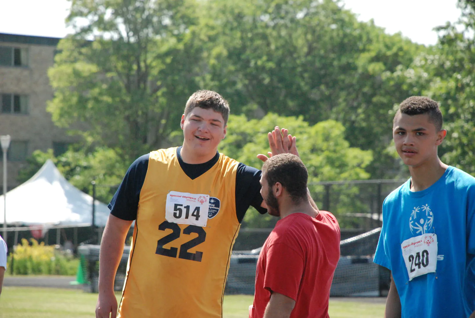 Athletes high-fiving after a race at the 2017 State Summer Games