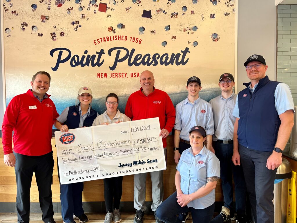 Special Olympics Wisconsin and Jersey Mike's staff pose with check from Month of Giving.