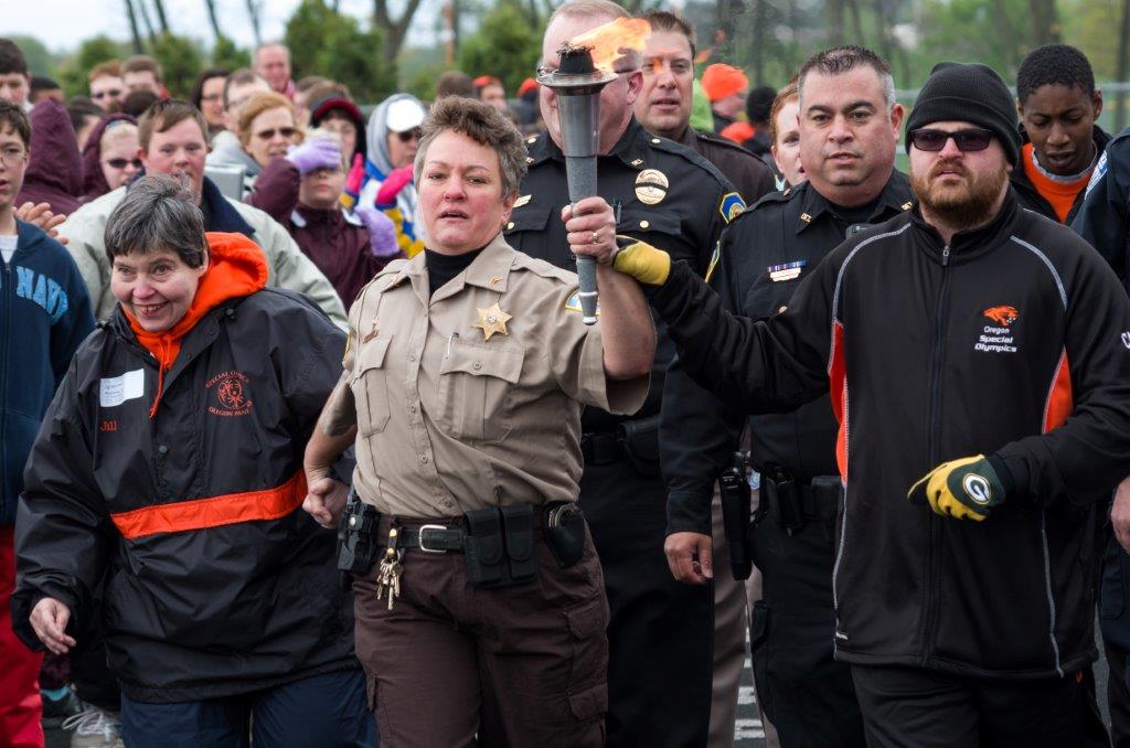 Dane County Sheriff's Deputy Lori Casper carries the torch with her son Jake