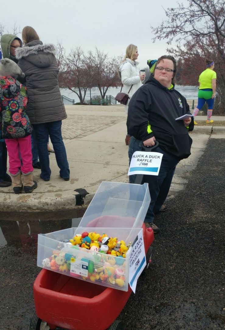 Adam really does have fun! Here he is selling ducks at the 2017 Whitewater Polar Plunge.