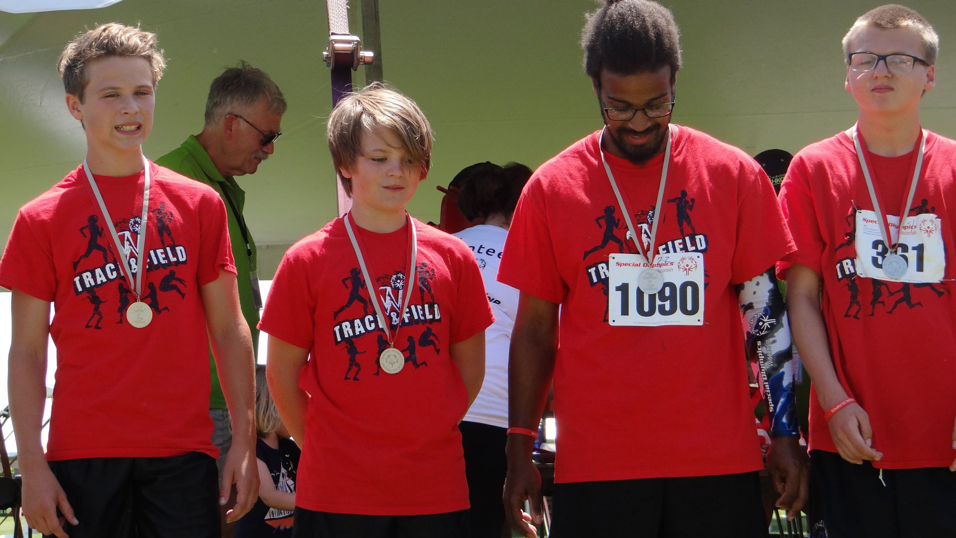 Kendrick (1090) on the medal stand after competing in Unified relay at the 2017 State Summer Games