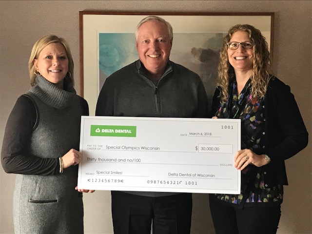 Delta Dental of Wisconsin's CEO Denny Peterson (center) and Director of Charitable Fund Ann Boson (right) present Missy Schoenbrodt with the grant check