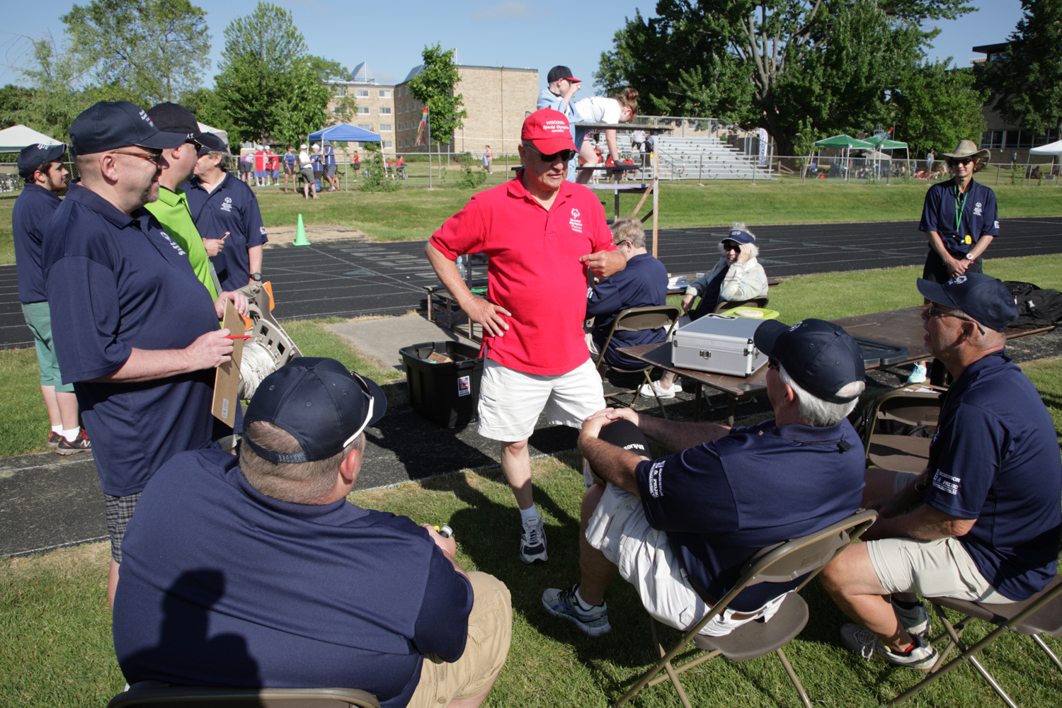 Semmens (red shirt) talks to his track officials during a break at the 2017 Summer Games