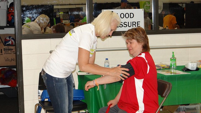 An athlete prepares to get her blood pressure checked