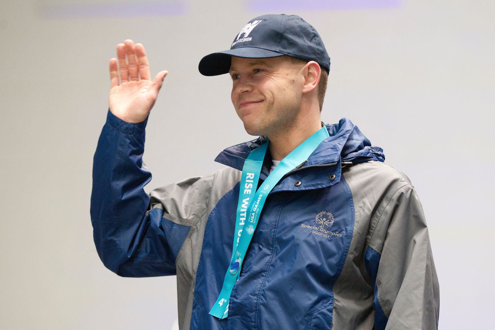 Swimmer Joshua Gorecki beams with pride after getting his fourth-place ribbon in his high-performance race