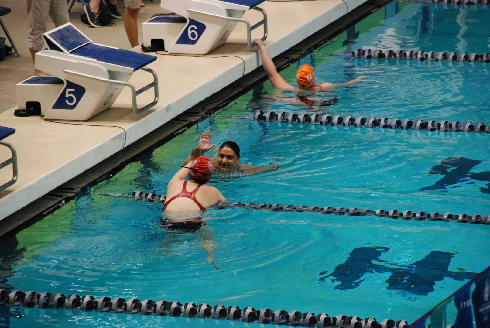 Sofia Walhovd shows Wisconsin sportsmanship when she congratulates a fellow swimmer after their heat