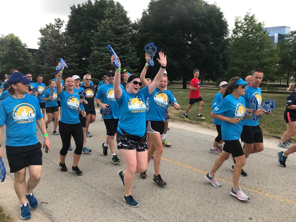 SOWI staff Britney Hoegh and Don Wigington, along with youth leaders Hannah Roehrig and Jessica Gerhartz of Brillion, participate in the Torch Run for Special Olympics' 50th anniversary