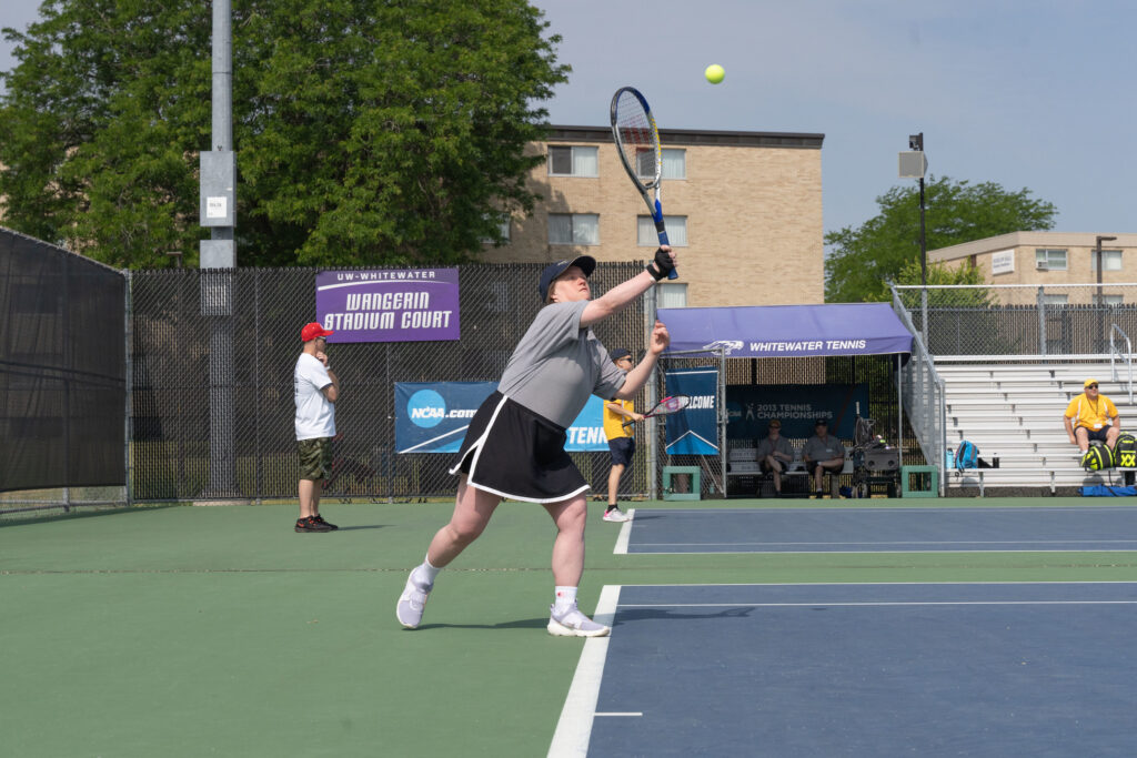 athlete serving during tennis competition