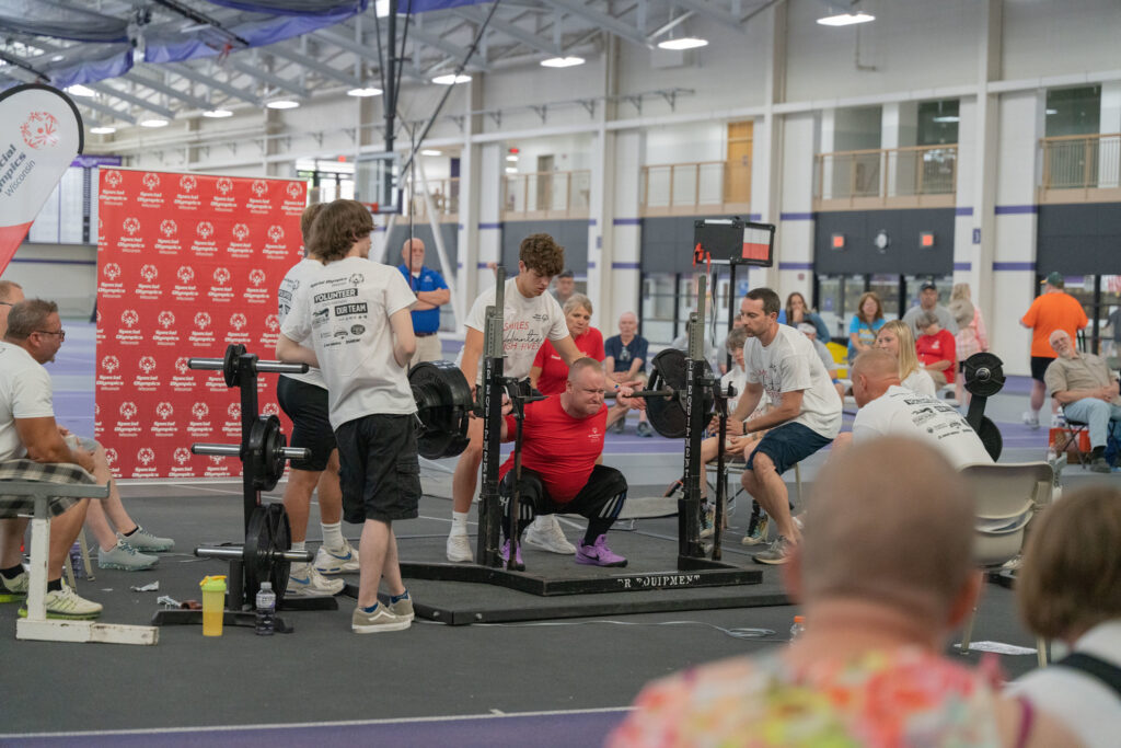 athlete performing squat during powerlifting competition